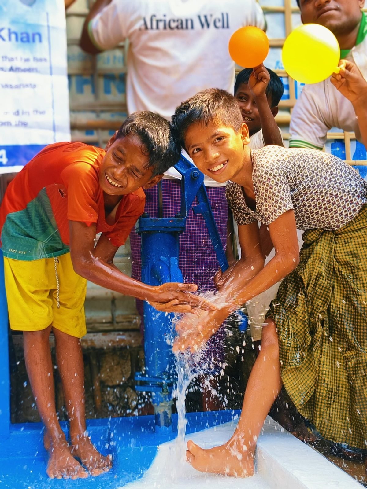 Children drinking from a new well